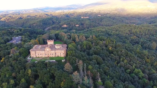 Aerial shot, gorgeous italian Sammezzano abbandoned castle, with the sun behind, filmed with drone