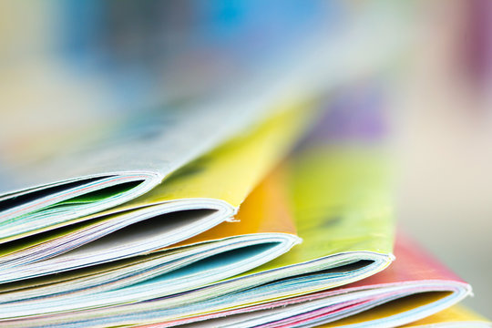 Close up edge of colorful magazine stacking 