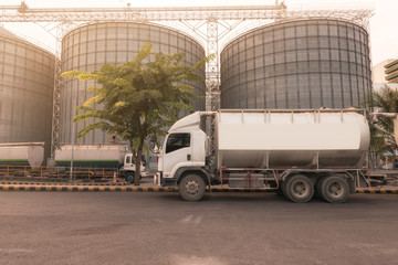 transport trucks feed for freight cargo and Grain storage silos.Business transport concept