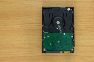 Computer hard drive on wooden background