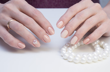 Amazing manicure and natural nails with gel polish. Attractive modern nail art design.