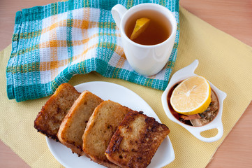 Tea, lemon and fried bread, top view 