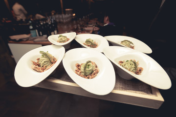 Waiter serving food in luxury dinner party, Blurry background wi