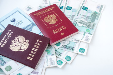 Foreign and Russian passport with passbooks lie on the money 