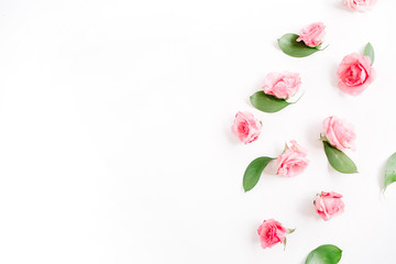 Pink roses buds on white background. Flat lay, top view. Valentine's background