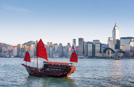Traditional Chinese wooden sailing ship with red sails