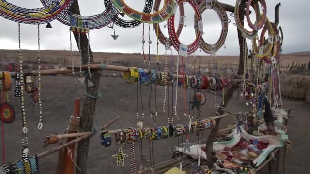 Handmade Maasai jewelry blowing in the ind in a village in tanzania