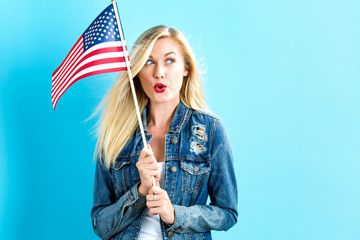 Young woman holding American flag - Powered by Adobe