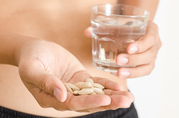 Medicine herb in hand and water,Alternative medicine,Herbal supplement pill