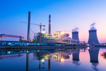 modern waterfront power plant at sunset - Powered by Adobe