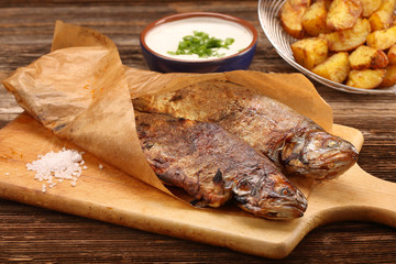 Baked fish with potatoes and white dip