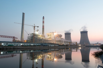 modern waterfront power plant at sunset
