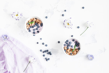 Obraz na płótnie Canvas Healthy breakfast with muesli and berries. Flat lay, top view