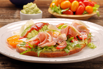 Fototapeta na wymiar Avocado sandwich on fresh bread with arugula