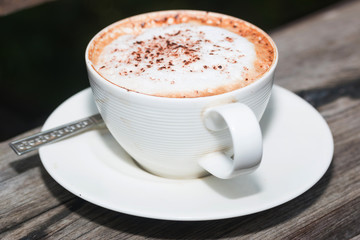 hot coffe on coffee cup on wood table
