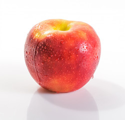 Apple on a white background. Waterdrops on Apple.