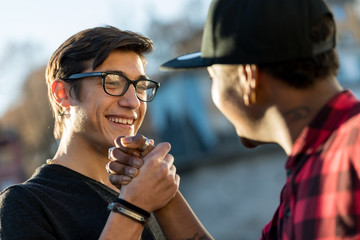 good friends joking about their secret handshake