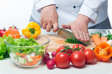 fresh vegetables on the table the cook prepares salad