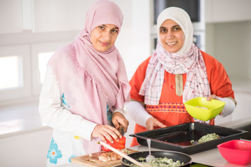 Muslim Arabic traditional woman in kitchen preparing food for lu