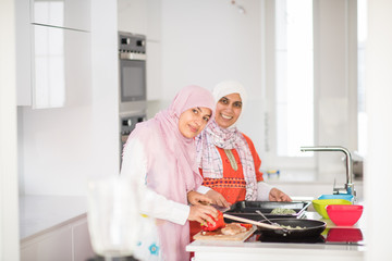 Fototapeta na wymiar Muslim Arabic traditional woman in kitchen preparing food for lu
