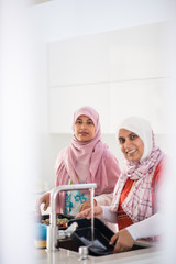 Muslim Arabic traditional woman in kitchen preparing food for lu
