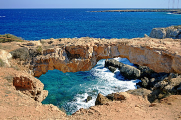 Natural stone bridge over the sea on the coast of Cyprus.
