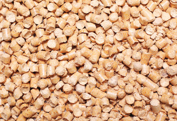 Many wooden pellets texture background top view
