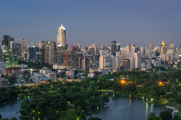 Lake and park surrounded by modern building in Bangkok city, Tha