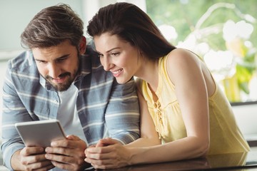Happy couple using digital tablet