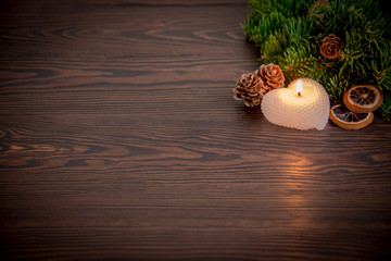 Warm winter composition with a candle / background