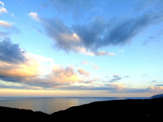 Sky and clouds with sun rays over the coast