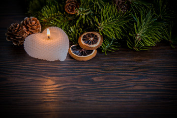 Warm winter composition with a candle / background