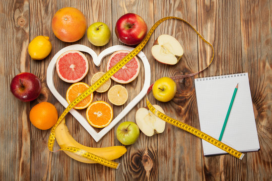 Fruit Diet, centimeter and plan on a wooden background