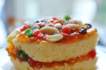 orange butter cake topping peanut and dried fruit salad on plate