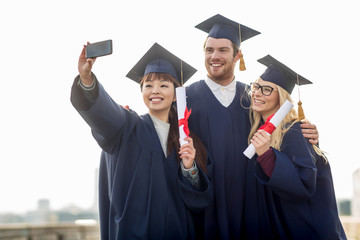 students or bachelors taking selfie by smartphone