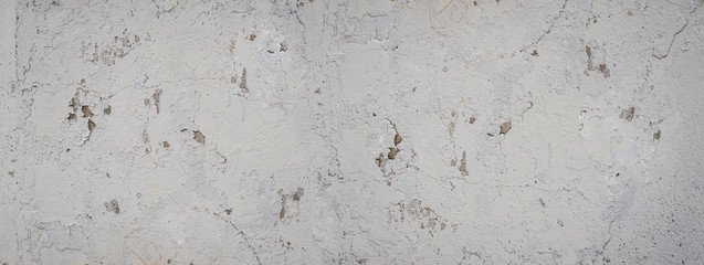 Grey abstract textured background cracked plaster. Texture of gray cracked paint wall. Background Plaster Wall Texture Gray