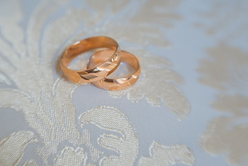 stylish gold wedding rings on a white table