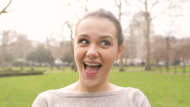 Portrait of a girl making faces and changing expressions. Beautiful young woman looking at camera and interacting with it
