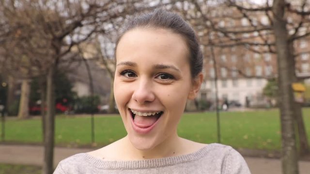 Portrait of a girl making faces and changing expressions. Beautiful young woman looking at camera and interacting with it