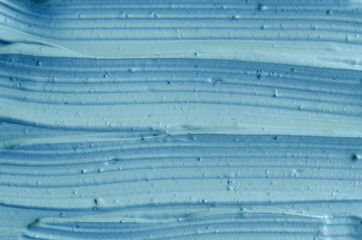 Blue cambrian cosmetic clay (facial mask, cream) texture close up, selective focus. Abstract background    