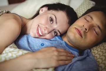 Obraz na płótnie Canvas Romantic couple relaxing on bed