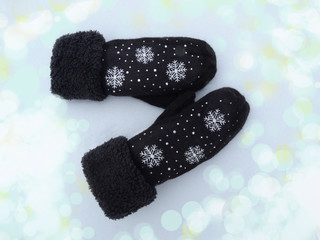 mittens winter clothes on snow background