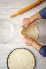 Cooking pizza dough on the kitchen