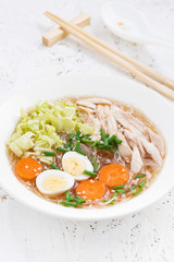 soup with glass noodles, vegetables and chicken, vertical