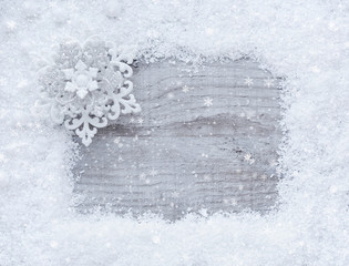 Christmas background with space for your text. Frame of snow on a wooden background.