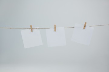 Three sticky notes hanging on clothes line