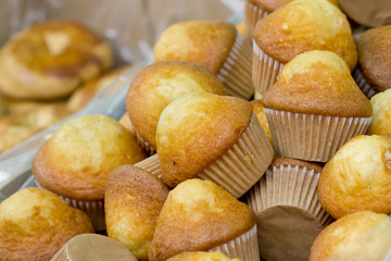 Closeup image of yellow muffins in a box.