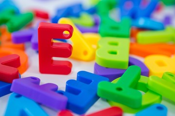 E alphabet standing between toy alphabet