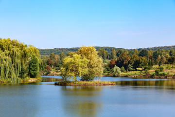 Sunny day and lake with island.