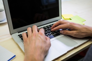 Graphic designer using digital tablet at his desk